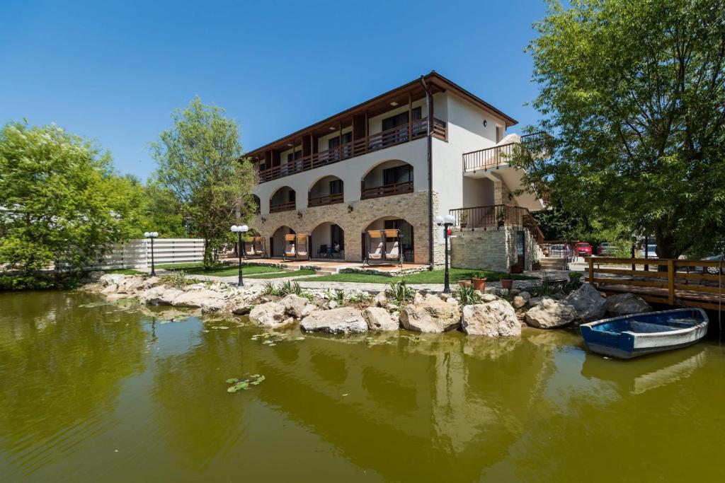 un edificio junto a un río con un barco en el agua en ViiLaLac, en Venus