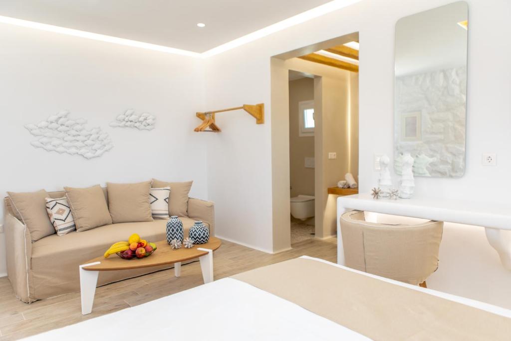 een witte woonkamer met een bank en een tafel bij Angeliki Apartments in Plaka