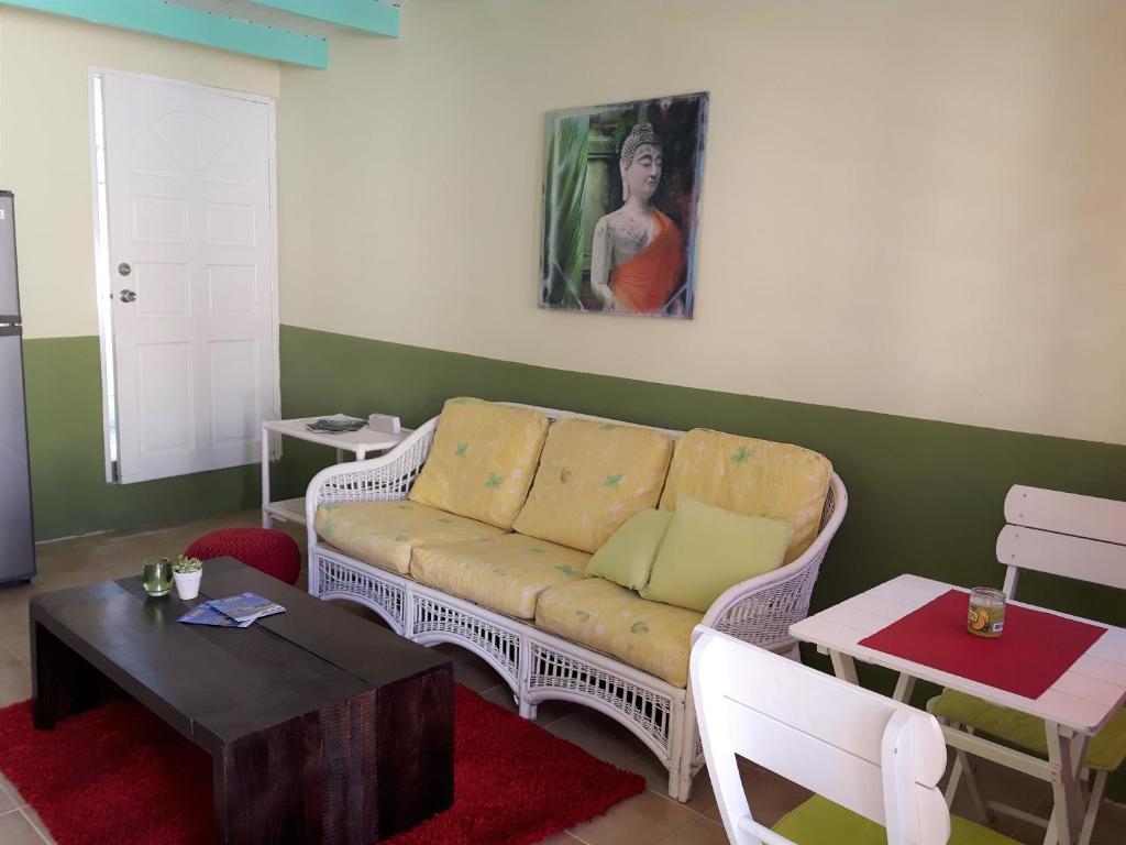 a living room with a couch and a table at SXM Spotters Paradise in Lowlands