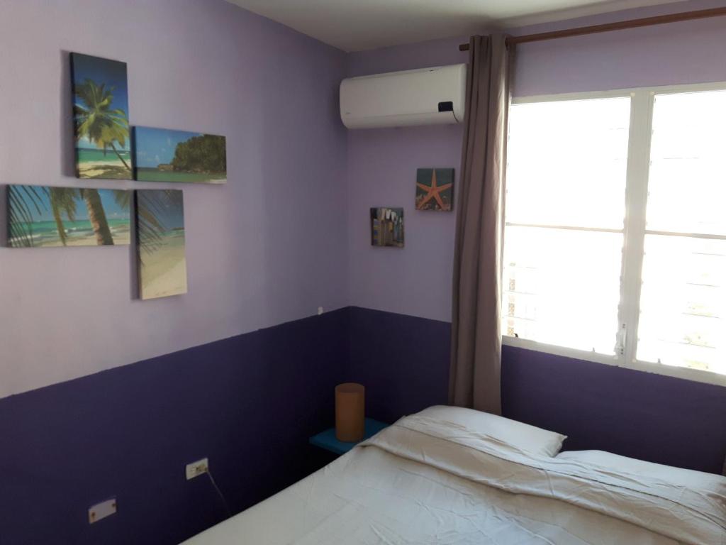 a bedroom with a bed and a window at SXM Spotters Paradise in Lowlands