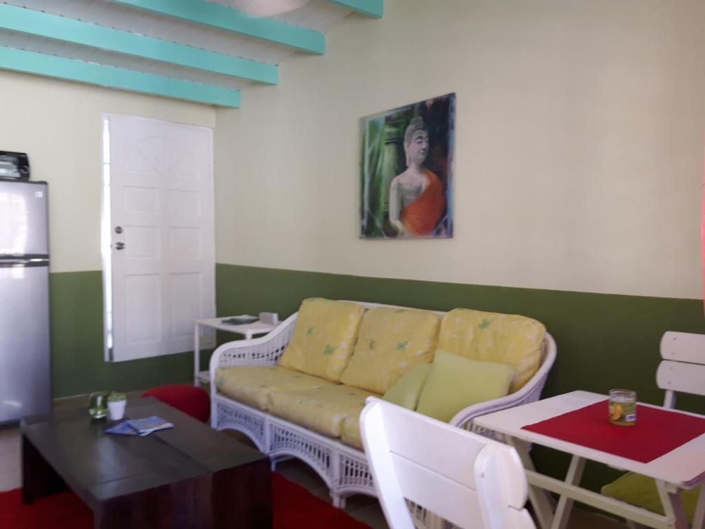a living room with a couch and a table at SXM Spotters Paradise in Lowlands