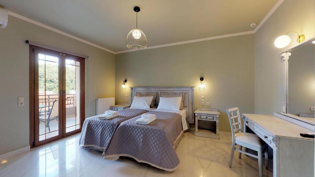 a bedroom with a bed with a desk and a desk at Parga Inn Suites in Parga