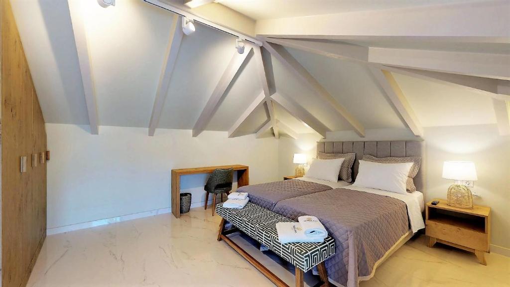 a bedroom with a bed and a desk in a room at Parga Inn Suites in Parga