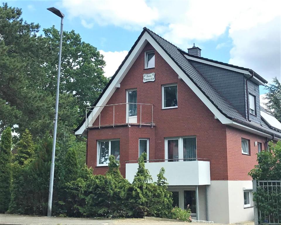 a large red brick house with a street light at Haus Sonnenschein in Timmendorfer Strand