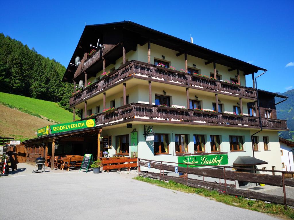 a large building with balconies on the side of it at Pension Gemshorn in Hainzenberg