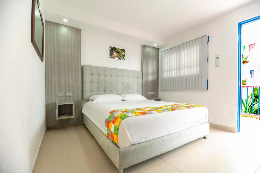Postel nebo postele na pokoji v ubytování Hotel El Jardin