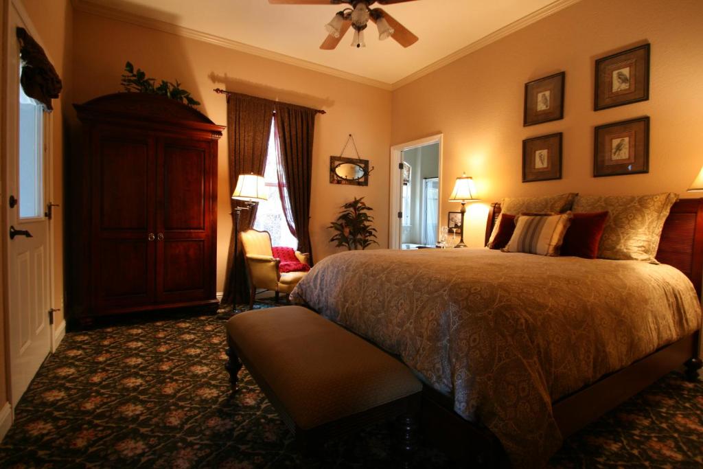 1 dormitorio con 1 cama y ventilador de techo en Yosemite Rose Bed and Breakfast en Groveland