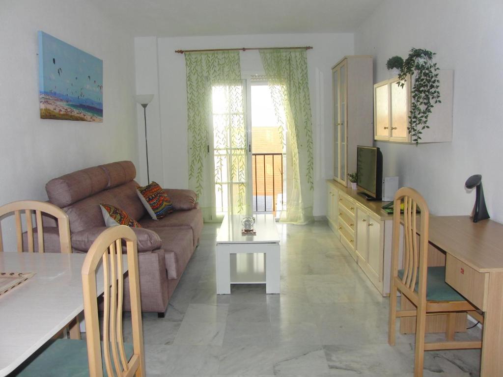 a living room with a couch and a table at Apartamento Junto a El Corte Inglés Algeciras 3 in Algeciras