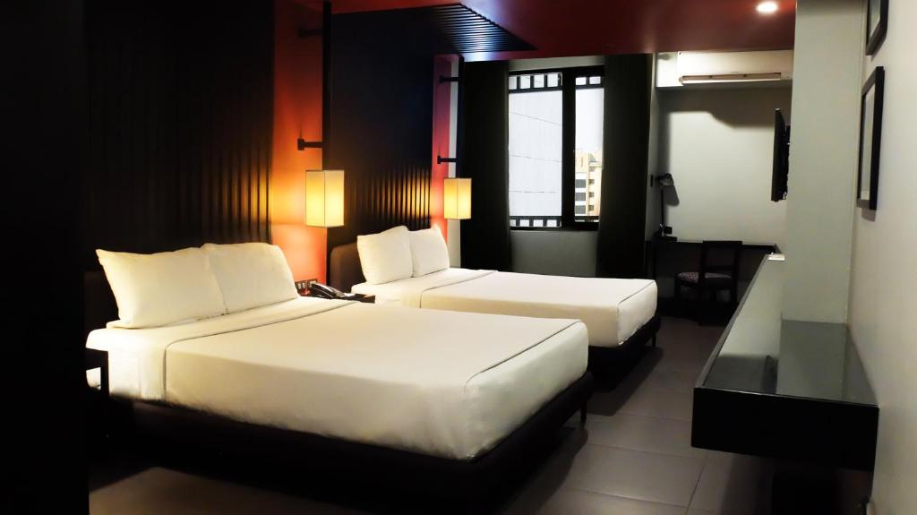 Postel nebo postele na pokoji v ubytování Amelie Hotel Manila