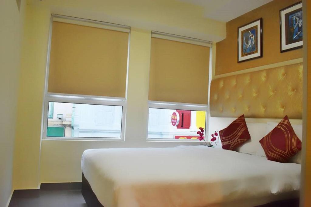 Postel nebo postele na pokoji v ubytování Sandpiper Hotel Singapore