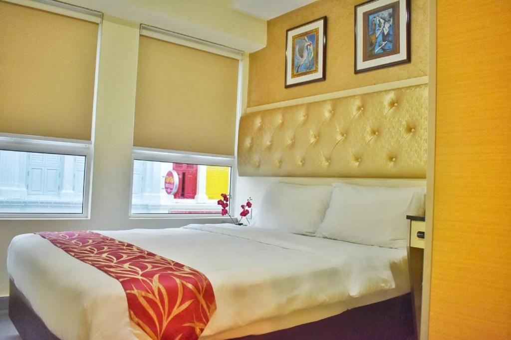 Postel nebo postele na pokoji v ubytování Sandpiper Hotel Singapore