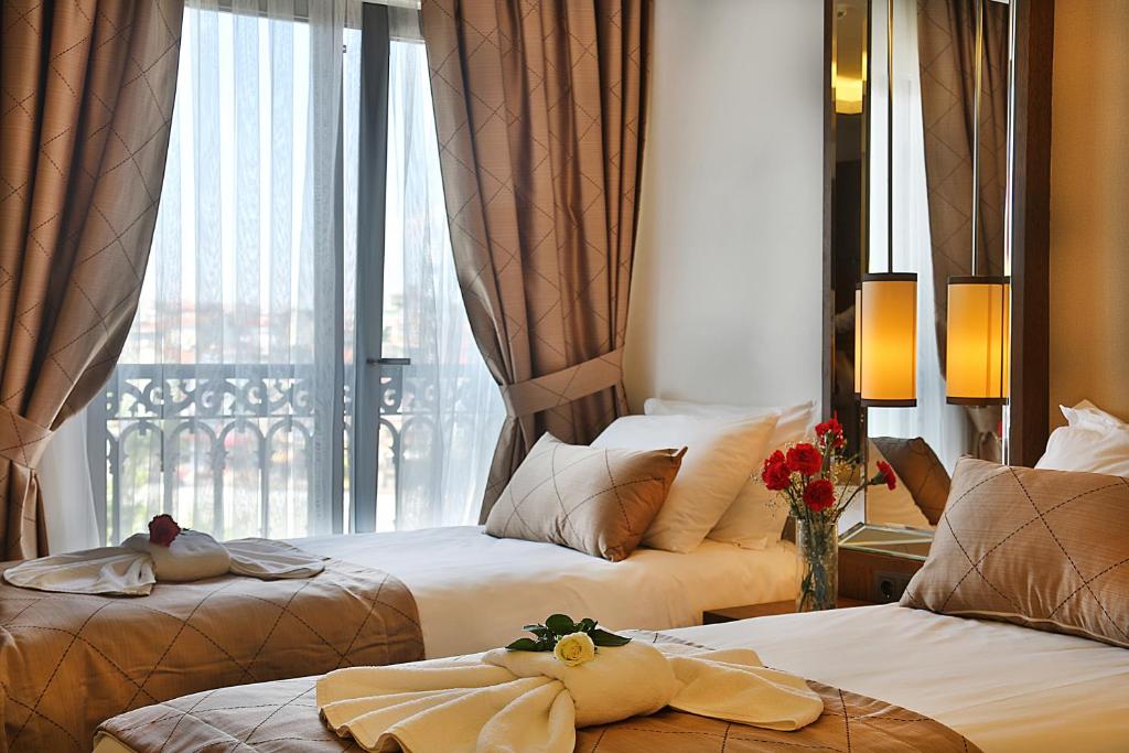 Postel nebo postele na pokoji v ubytování Grand Sagcanlar Hotel
