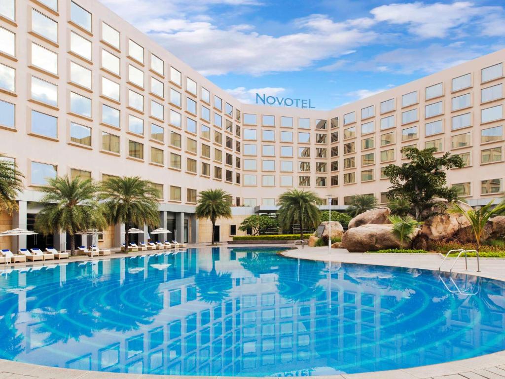 a view of the novation hotel with a large swimming pool at Novotel Hyderabad Convention Centre in Hyderabad