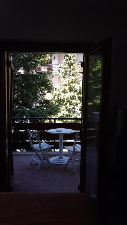 a table and two chairs on a patio with a window at Raggio di Luna in Roccaraso