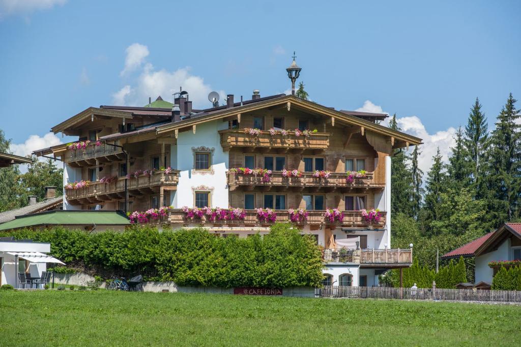 ein großes Haus mit Blumenkästen auf dem Balkon in der Unterkunft Hotel Pension Wiesenhof in Kaltenbach