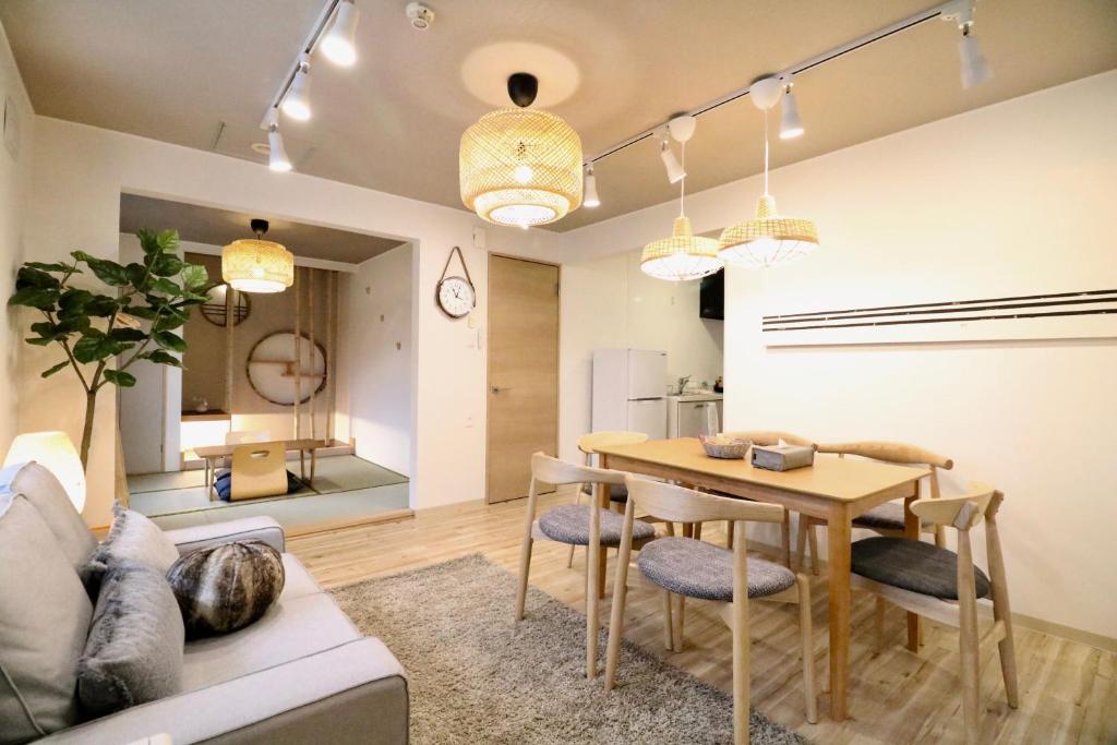 ein Wohnzimmer mit einem Tisch und einem Sofa in der Unterkunft Sky Court 717 in Sapporo