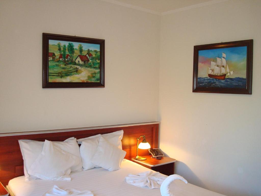 Postel nebo postele na pokoji v ubytování Hotel Ami