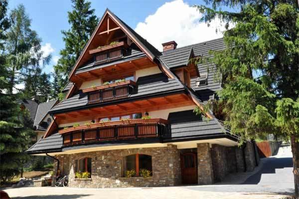a large house with a gambrel roof at Willa Apart in Zakopane