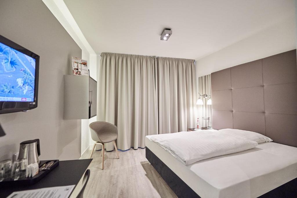 Postel nebo postele na pokoji v ubytování Hotel Amadeus
