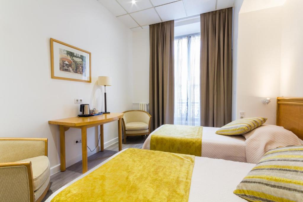 Cama o camas de una habitaci&oacute;n en Hotel Busby