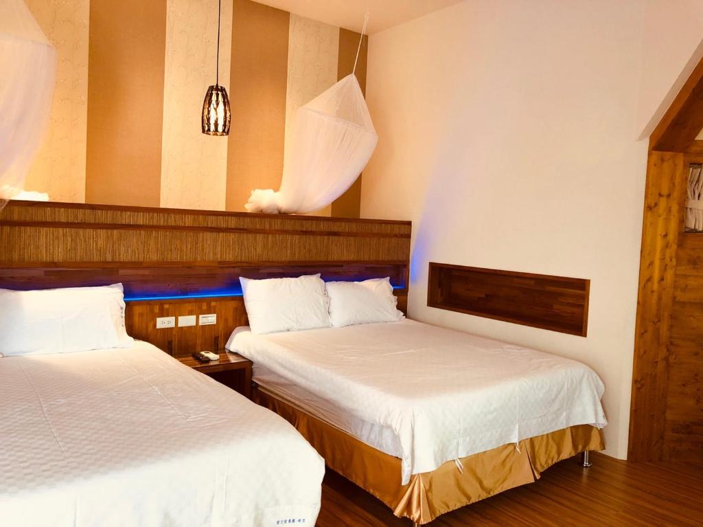 Postel nebo postele na pokoji v ubytování 晴空桂冠 Clear Sky Laurel Hotel