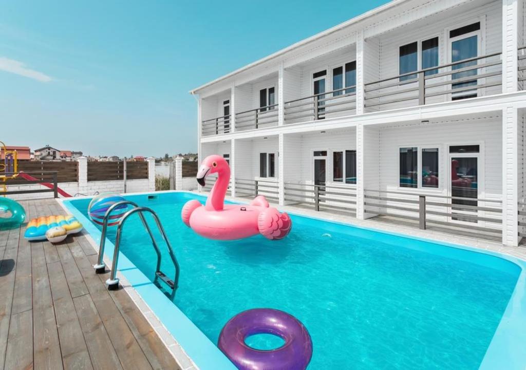 a pool with a pink inflatable flamingo in the water at SeaZone in Zatoka