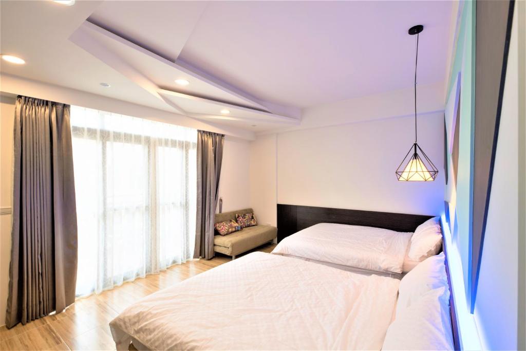 Postel nebo postele na pokoji v ubytování 晴空桂冠 Clear Sky Laurel Hotel