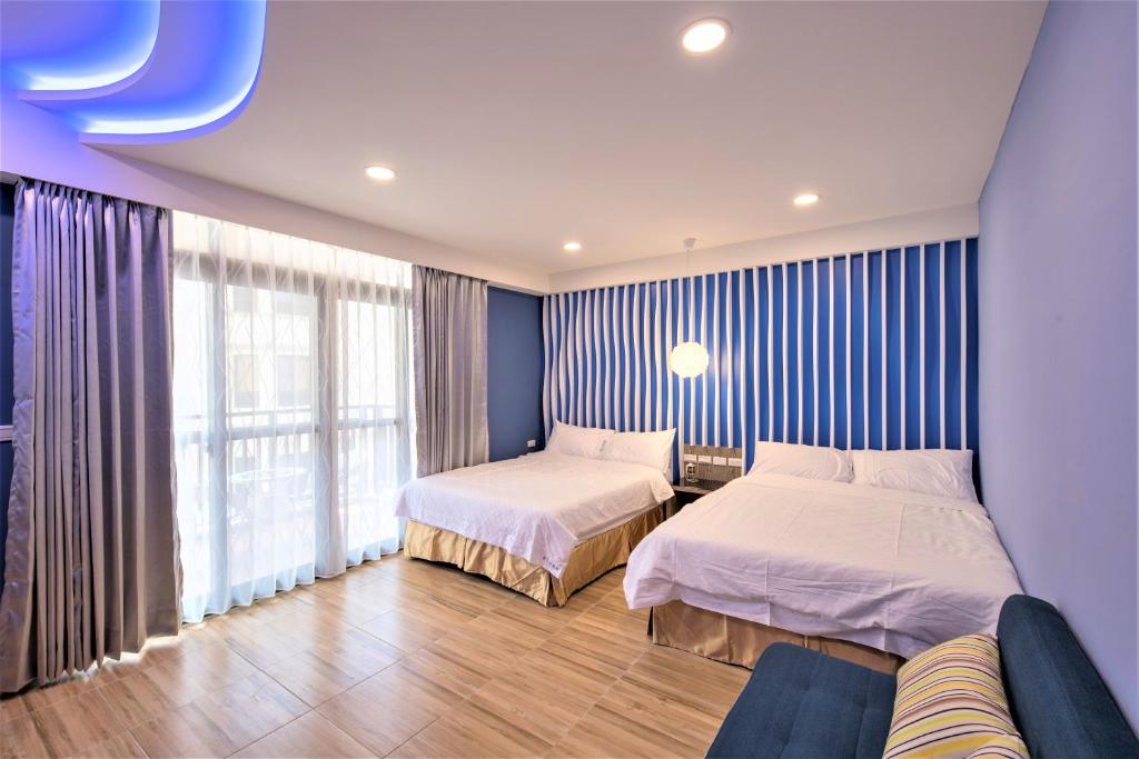 Postel nebo postele na pokoji v ubytování 晴空桂冠 Clear Sky Laurel Hotel