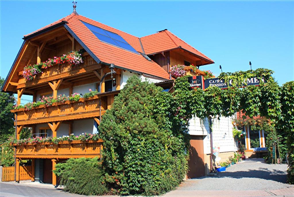 a building with flower boxes on the side of it at Cafe & Pension Carmen in Brotterode-Trusetal
