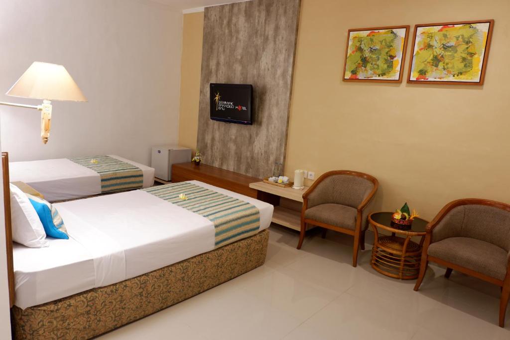 Postel nebo postele na pokoji v ubytování Seminyak Paradiso Hotel