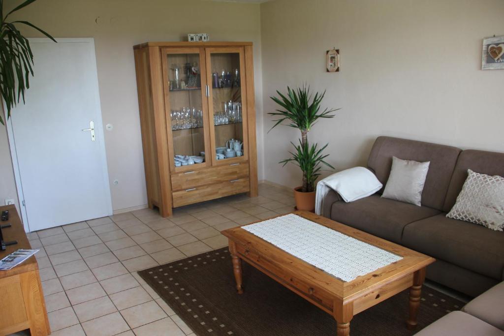 a living room with a couch and a coffee table at Ferienhof Pöhlmann in Wunsiedel