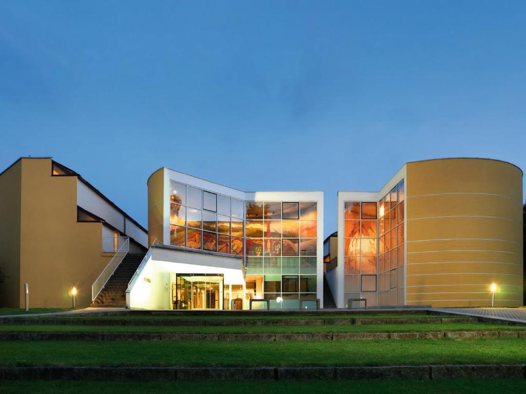 a rendering of a building at night at Hotel St. Virgil Salzburg in Salzburg