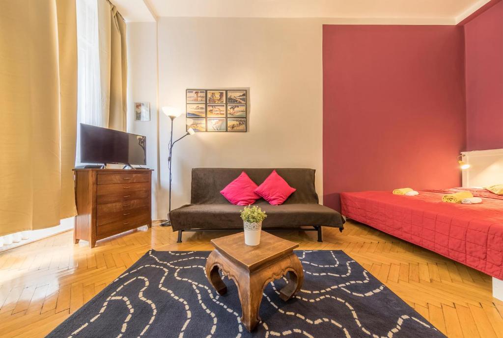 a living room with a couch and a bed at Miso Apartment in Budapest