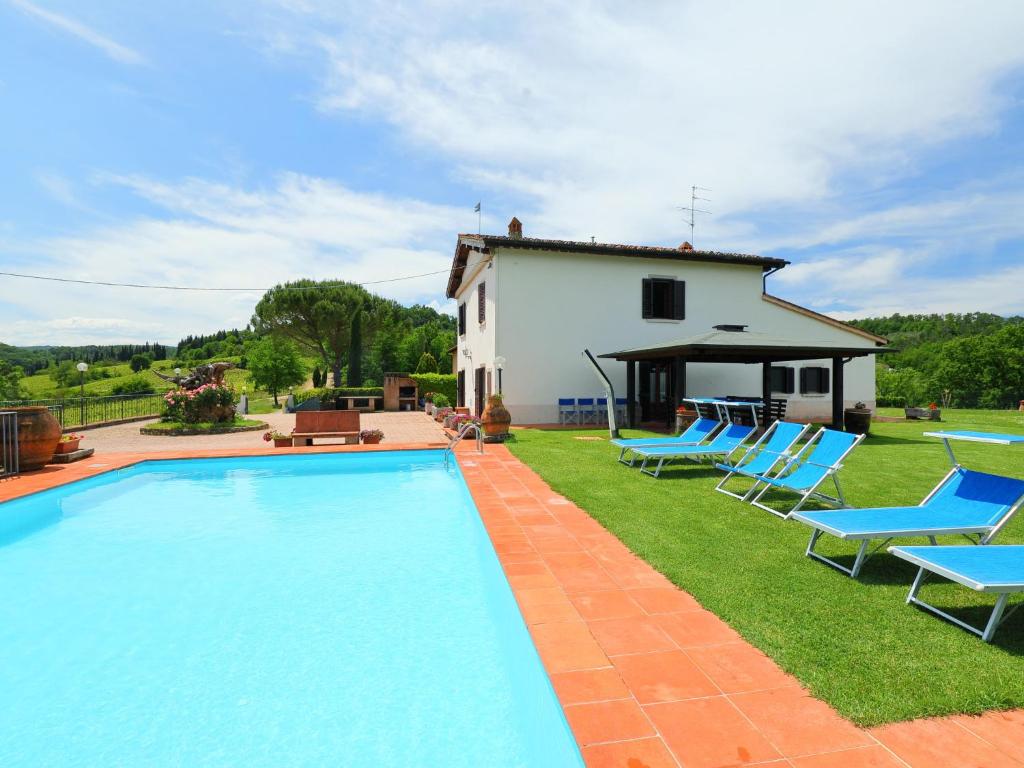 a villa with a swimming pool in front of a house at Holiday Home Il Poggetto by Interhome in Mercatale Val Di Pesa