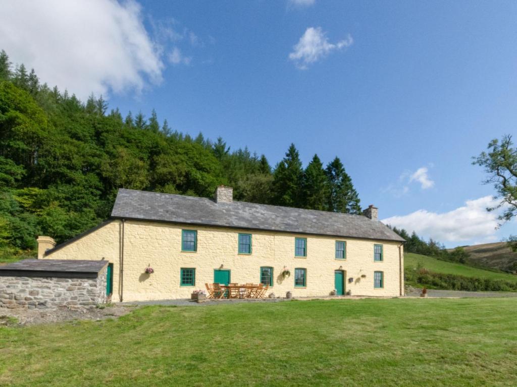 a large white house on a grassy field at Holiday Home Ty Llan by Interhome in Llanwrtyd