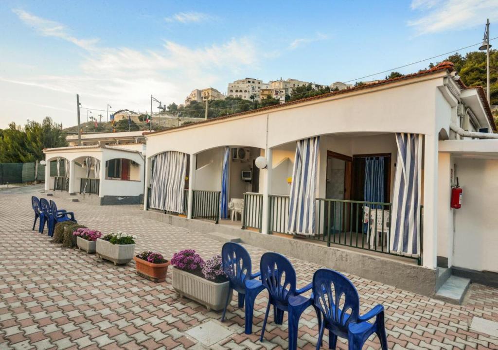 a row of blue chairs in front of a building at Residence Dattoli in Peschici