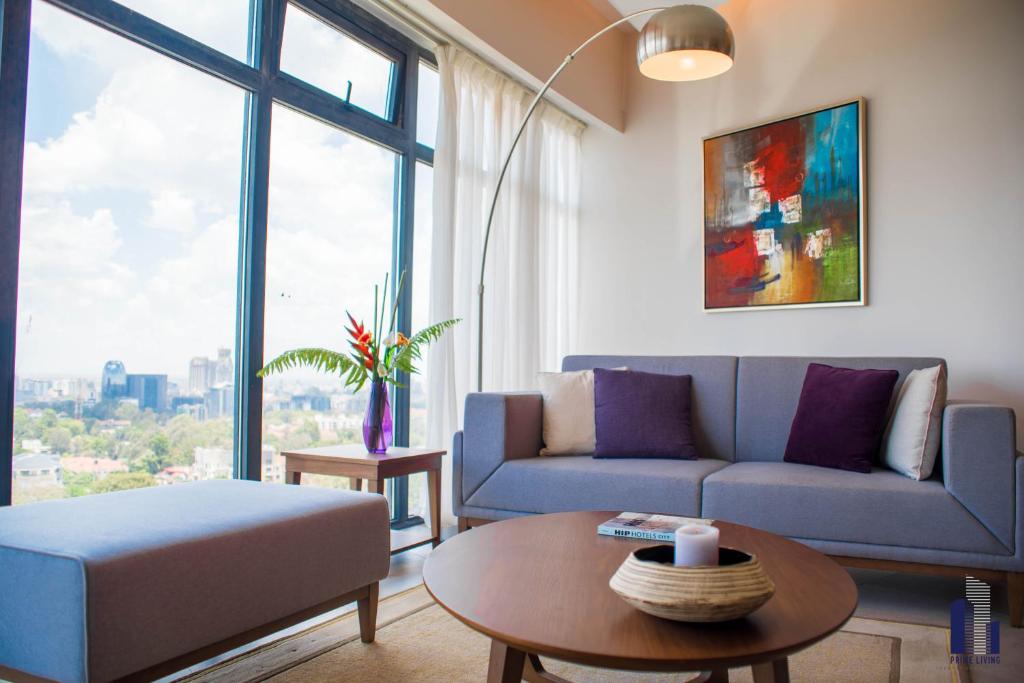 a living room with a couch and a table at Prime Living Luxury Apartments in Nairobi