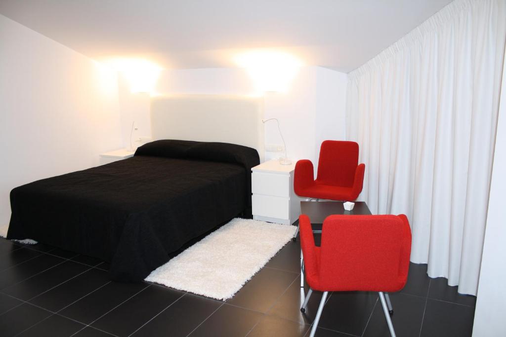 Posteľ alebo postele v izbe v ubytovaní Hostal Tres Campanas