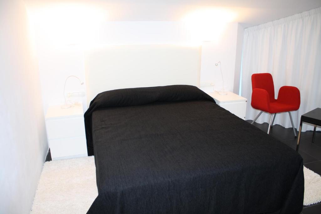 Posteľ alebo postele v izbe v ubytovaní Hostal Tres Campanas