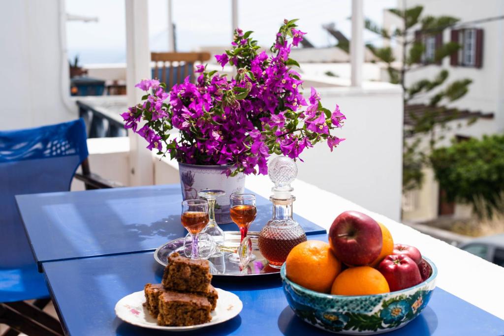- une table avec deux assiettes de nourriture et des verres de vin dans l'établissement Calderimi Apartments, à Fira