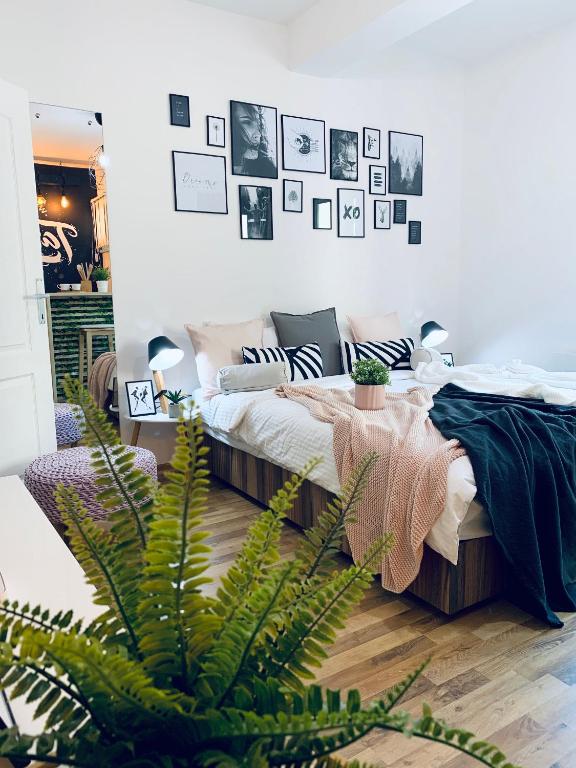 a bedroom with a bed and a plant at Apartment Take a breath in Vrnjačka Banja