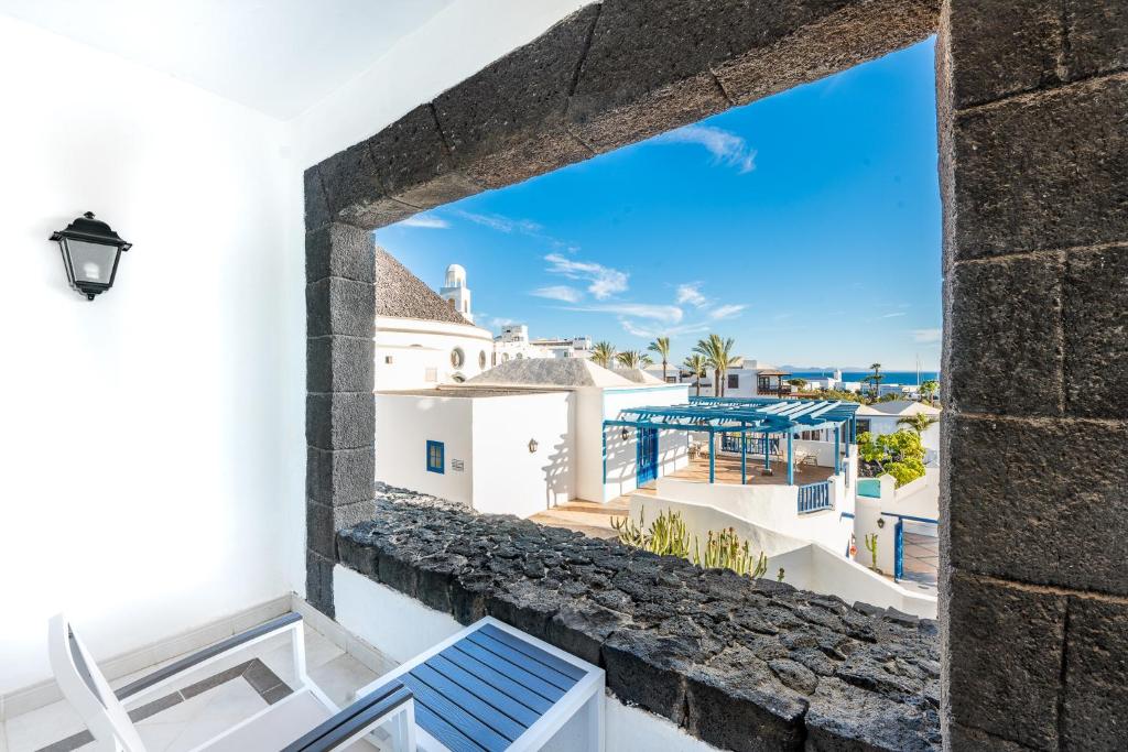 a view from the balcony of a villa with white buildings at Hotel LIVVO Volcán Lanzarote in Playa Blanca