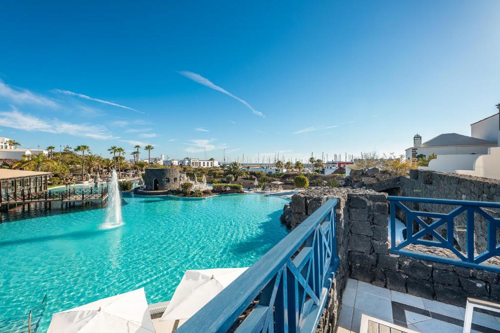 a pool at a resort with a fountain at Hotel LIVVO Volcán Lanzarote in Playa Blanca