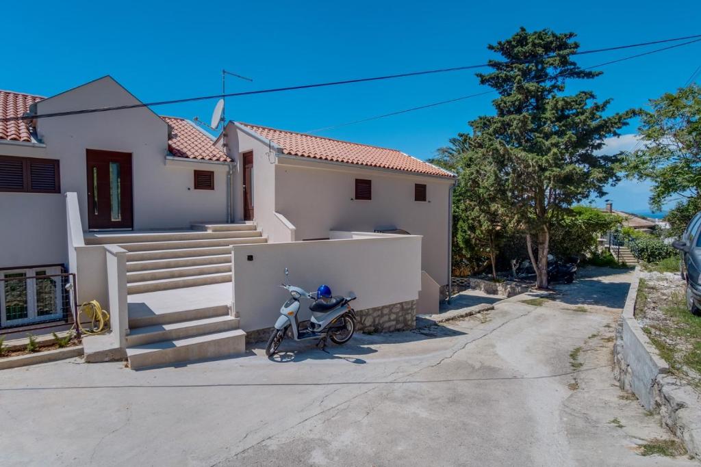 a motorcycle parked in front of a house at Wonderful House Sandra in Mali Lošinj