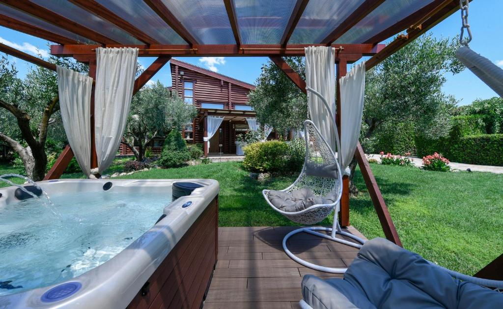 a hot tub in a backyard with a gazebo at Lakkia - Wooden Residence in Lakkiá