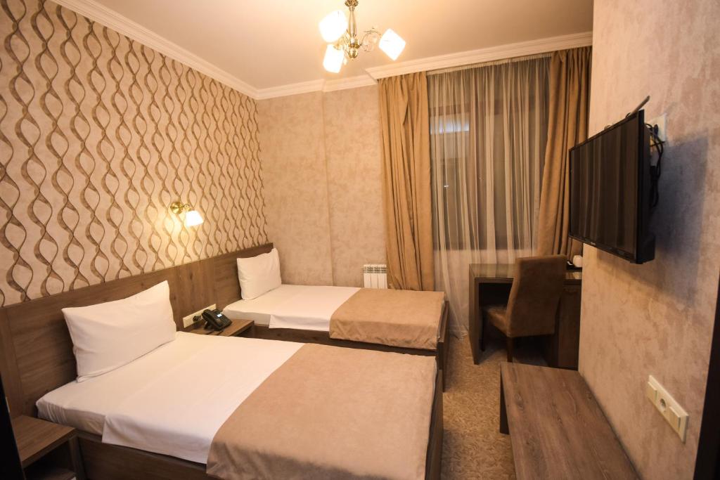 Postel nebo postele na pokoji v ubytování Old Garden Hotel Batumi