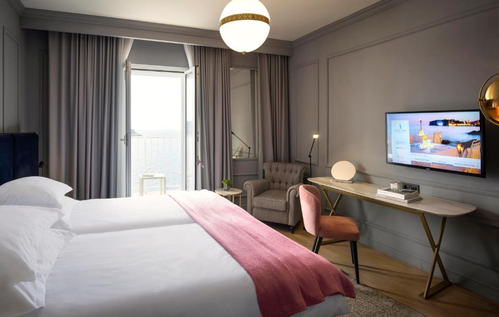 a hotel room with a bed and a television at Hotel Excelsior in Dubrovnik