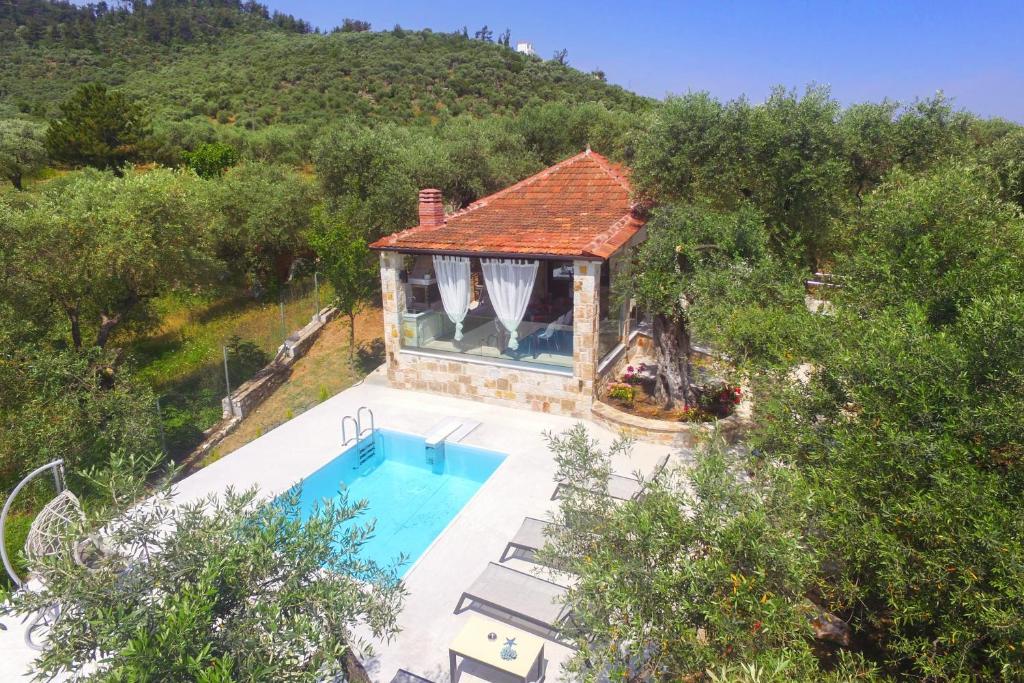 an aerial view of a house with a swimming pool at villa Santa Marina in Makryámmos