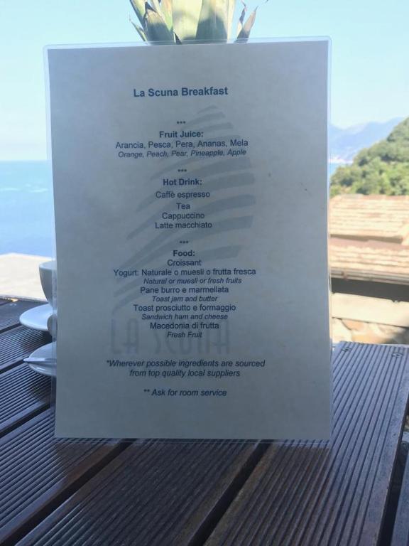 a menu for a restaurant sitting on top of a table at il Magàn - Cinque Terre in Corniglia