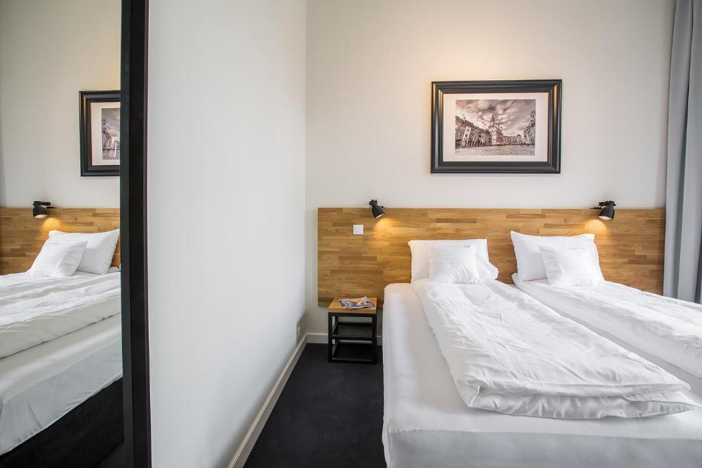 Posteľ alebo postele v izbe v ubytovaní Loft Apartments Poznań